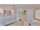 Cozy Bedroom with a white crib, dresser, pink accents, and checker patterned walls at 6372 English Creek Dr, Lakeland, FL 33811
