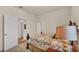 Comfortable bedroom with a decorative bed, neutral tones, and an open doorway at 6372 English Creek Dr, Lakeland, FL 33811