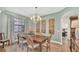 Traditional dining room with hardwood floors, elegant chandelier, and light-colored walls at 6372 English Creek Dr, Lakeland, FL 33811