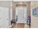 Foyer with stylish wallpaper, wood floors, and a bright white front door at 6372 English Creek Dr, Lakeland, FL 33811