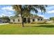 Charming single-story home with a well-maintained lawn and mature tree at 6372 English Creek Dr, Lakeland, FL 33811
