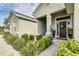 Close-up of home's entry featuring a fountain and lush landscaping at 6372 English Creek Dr, Lakeland, FL 33811