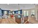 Spacious kitchen featuring large island, stainless appliances, wood cabinets, and open layout to living area at 6372 English Creek Dr, Lakeland, FL 33811