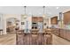 Modern kitchen featuring a large island with seating, wood cabinets, stainless appliances, and open concept layout at 6372 English Creek Dr, Lakeland, FL 33811