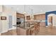 Open-concept kitchen with central island, stainless appliances, dark wood cabinets, and breakfast bar seating at 6372 English Creek Dr, Lakeland, FL 33811