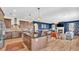 Open kitchen with dark wood cabinets, granite countertops, stainless steel appliances, and seamless access to living room at 6372 English Creek Dr, Lakeland, FL 33811