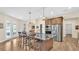 Bright kitchen with a central island, stainless steel appliances, wood cabinetry, and open-concept design at 6372 English Creek Dr, Lakeland, FL 33811