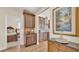 Transitional kitchenette featuring wood cabinets, stainless steel appliances, and decorative backsplash at 6372 English Creek Dr, Lakeland, FL 33811