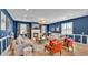 Cozy living room with fireplace, blue walls, wood flooring, and stylish curtains at 6372 English Creek Dr, Lakeland, FL 33811