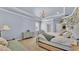 Airy main bedroom with accent wallpaper, a chandelier, and classic decor at 6372 English Creek Dr, Lakeland, FL 33811