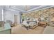 Main bedroom featuring tray ceilings, a decorative accent wall, and soft lighting at 6372 English Creek Dr, Lakeland, FL 33811