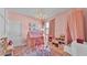 Bright playroom includes a tent, ' table, storage shelves, and soft pink decor at 6372 English Creek Dr, Lakeland, FL 33811
