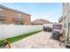 A cozy, fenced backyard with a paved patio and some grass at 6506 Sedgeford Dr, Lakeland, FL 33811