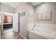 Bathroom has a tub, walk-in shower and is next to the primary bedroom at 6506 Sedgeford Dr, Lakeland, FL 33811