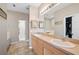 Primary bathroom with double sinks, soaking tub, walk-in shower, and tile floors at 6506 Sedgeford Dr, Lakeland, FL 33811