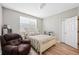 Bright bedroom featuring a cozy chair, queen bed, and a large window at 6506 Sedgeford Dr, Lakeland, FL 33811