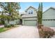 Charming townhome featuring a brick driveway, two-car garage, and well-maintained landscaping at 6506 Sedgeford Dr, Lakeland, FL 33811