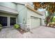 Lovely townhome entrance showcasing a brick paved driveway, a wreath on the front door, and a two-car garage at 6506 Sedgeford Dr, Lakeland, FL 33811