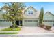 Inviting townhome with a two-car garage, manicured landscaping, and charming curb appeal at 6506 Sedgeford Dr, Lakeland, FL 33811