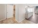 Tiled hallway leading to a cozy living room and a half bathroom, creating a welcoming atmosphere at 6506 Sedgeford Dr, Lakeland, FL 33811