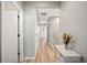 Hallway with wood floors has white doors and beige paint with a view to the staircase at 6506 Sedgeford Dr, Lakeland, FL 33811