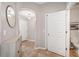 Hallway featuring an arched doorway, decor, access to a half bath, and the home's front entrance at 6506 Sedgeford Dr, Lakeland, FL 33811