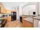 Functional kitchen features light wood cabinets, black appliances, and a breakfast bar for casual dining at 6506 Sedgeford Dr, Lakeland, FL 33811
