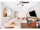 Bright and airy living room with hardwood floors, a large sectional sofa, and seamless kitchen access at 6506 Sedgeford Dr, Lakeland, FL 33811