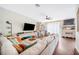 Cozy living room boasts a sectional sofa, built-in shelves, and a large television for entertainment at 6506 Sedgeford Dr, Lakeland, FL 33811