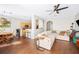 Spacious living room featuring sleek floors, a comfortable sectional, and seamless access to the kitchen at 6506 Sedgeford Dr, Lakeland, FL 33811