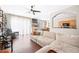 Bright living room featuring a large sectional sofa, wood floors, and an open concept design to the kitchen at 6506 Sedgeford Dr, Lakeland, FL 33811