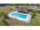 Aerial view of a fenced community pool with ample seating and landscaping at 6506 Sedgeford Dr, Lakeland, FL 33811