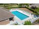 Relaxing community pool with lounge chairs and tables, perfect for hot summer days at 6506 Sedgeford Dr, Lakeland, FL 33811