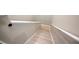 Bright staircase with wood-look floors and white risers has a white railing on both sides at 6506 Sedgeford Dr, Lakeland, FL 33811