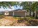 Backyard featuring home exterior, green grass, and foliage at 6625 Thornhill Rd, Winter Haven, FL 33880