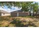 A backyard featuring a back door and grass at 6625 Thornhill Rd, Winter Haven, FL 33880