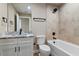 Bathroom with tiled shower, single vanity, and toilet at 6625 Thornhill Rd, Winter Haven, FL 33880