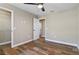 Bedroom with wood-look floors, closet, and open door to hallway at 6625 Thornhill Rd, Winter Haven, FL 33880