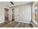 Bedroom with wood-look floors, closet, and attached bathroom at 6625 Thornhill Rd, Winter Haven, FL 33880
