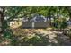 Rear exterior view of the home showcasing the yard, trees, and back door at 6625 Thornhill Rd, Winter Haven, FL 33880