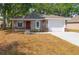 Charming single-story home featuring a red front door, attached garage, and stone accents on the facade at 6625 Thornhill Rd, Winter Haven, FL 33880