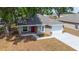 Aerial view of a single-story home with a freshly paved driveway, manicured front yard, and new landscaping at 6625 Thornhill Rd, Winter Haven, FL 33880