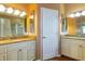 Double vanity bathroom featuring granite countertops, decorative mirrors, and custom cabinets at 6626 Royal Forest Dr, Lakeland, FL 33811