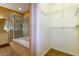 Bright bathroom features a glass shower, soaking tub, and walk-in closet at 6626 Royal Forest Dr, Lakeland, FL 33811