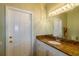 Bathroom with granite countertop vanity and a large mirror with decorative light fixture at 6626 Royal Forest Dr, Lakeland, FL 33811