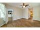 Spacious bedroom with wood-look tile floors and access to the kitchen and bathroom at 6626 Royal Forest Dr, Lakeland, FL 33811