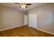 Bedroom featuring wood-look tile floors, a ceiling fan, and a white closet at 6626 Royal Forest Dr, Lakeland, FL 33811