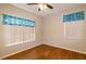Bedroom featuring wood-look tile floors, a ceiling fan, and a window with valance at 6626 Royal Forest Dr, Lakeland, FL 33811