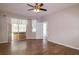 Spacious bedroom featuring wood-look tile floors, ceiling fan, and access to a patio at 6626 Royal Forest Dr, Lakeland, FL 33811