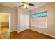 Bedroom featuring wood-look tile floors, a ceiling fan, closet, and a window with valance at 6626 Royal Forest Dr, Lakeland, FL 33811